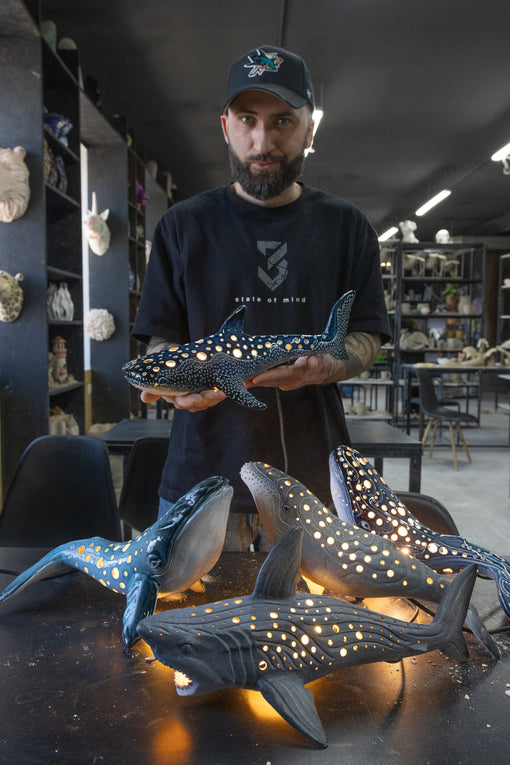 KUST ceramics studio and the founder holds the whale shark lamp on hands