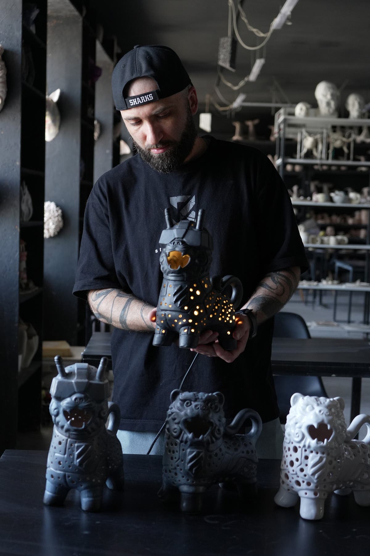 Viktor Kushchenko is holding ceramic lamps created to support the 3 army corps