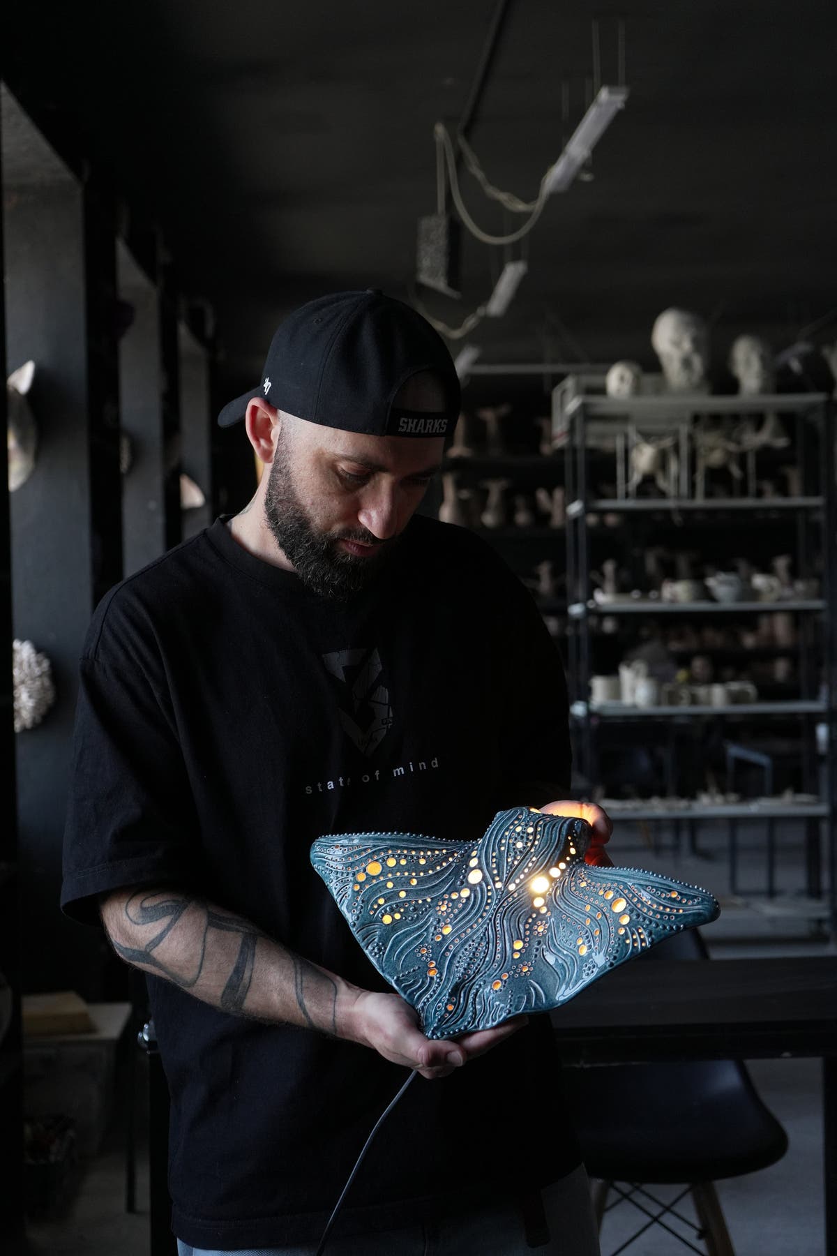 Viktor Kushchenko is holding manta ray ceramic wall lamp