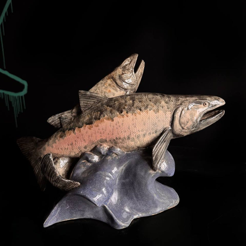 Decorative sculpture of a salmon on a dark background
