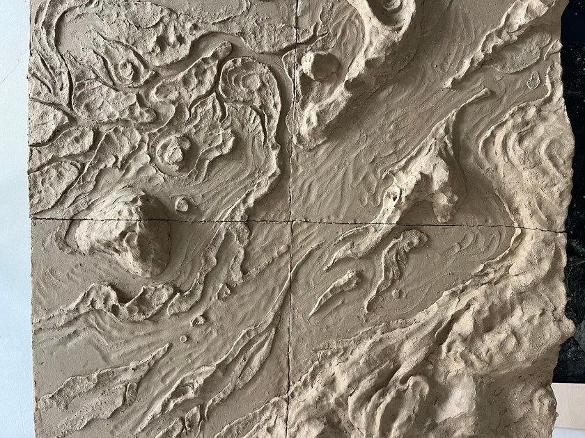 Textured wall panel with embossed patterns resembling natural landscapes