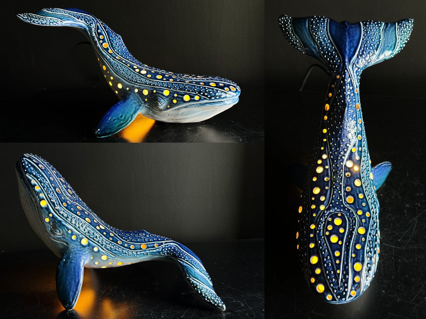 Decorative whale sculpture with blue and yellow pattern on a dark background