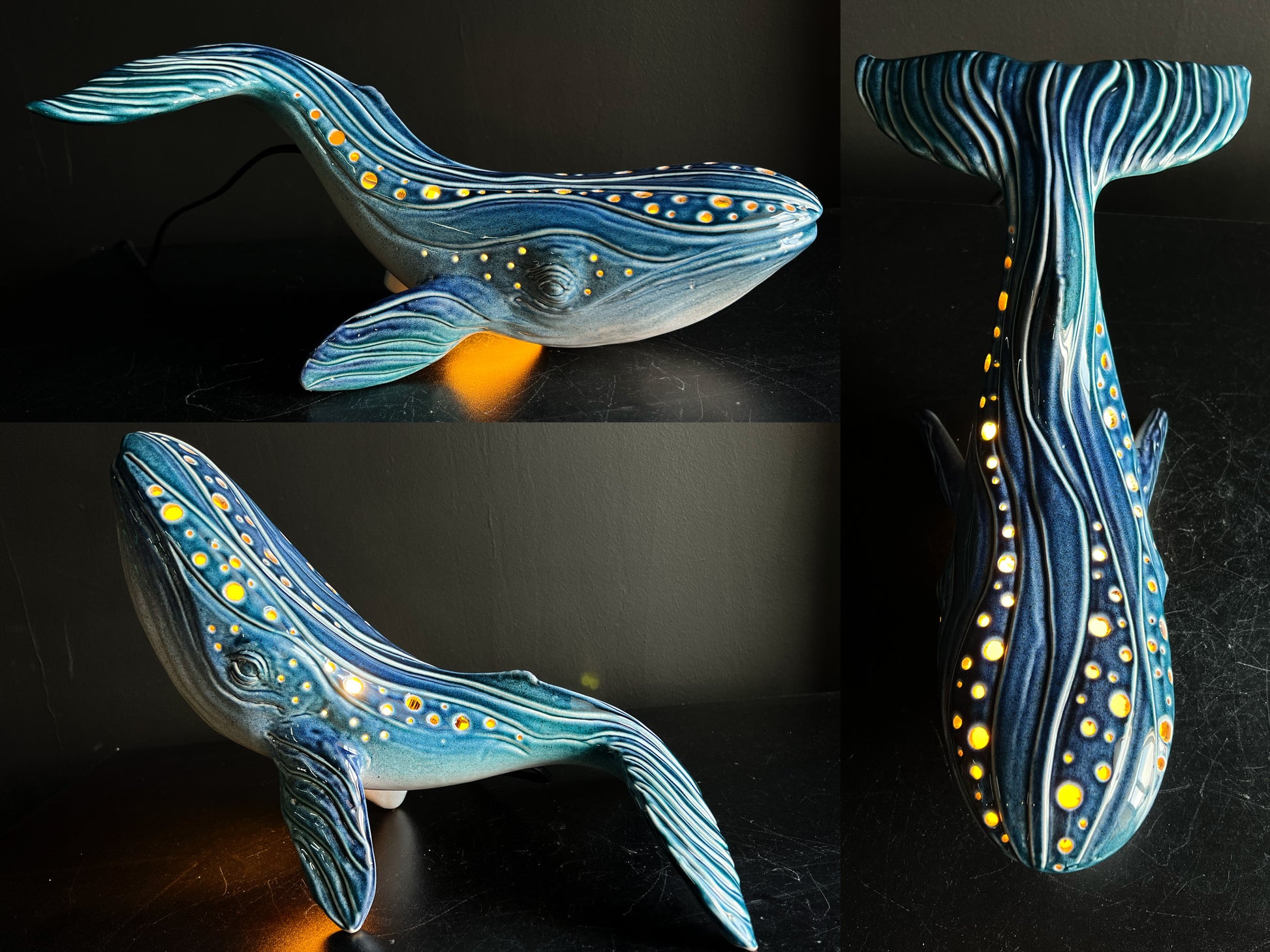 Ceramic sculpture of a whale with blue and yellow patterns on a dark background