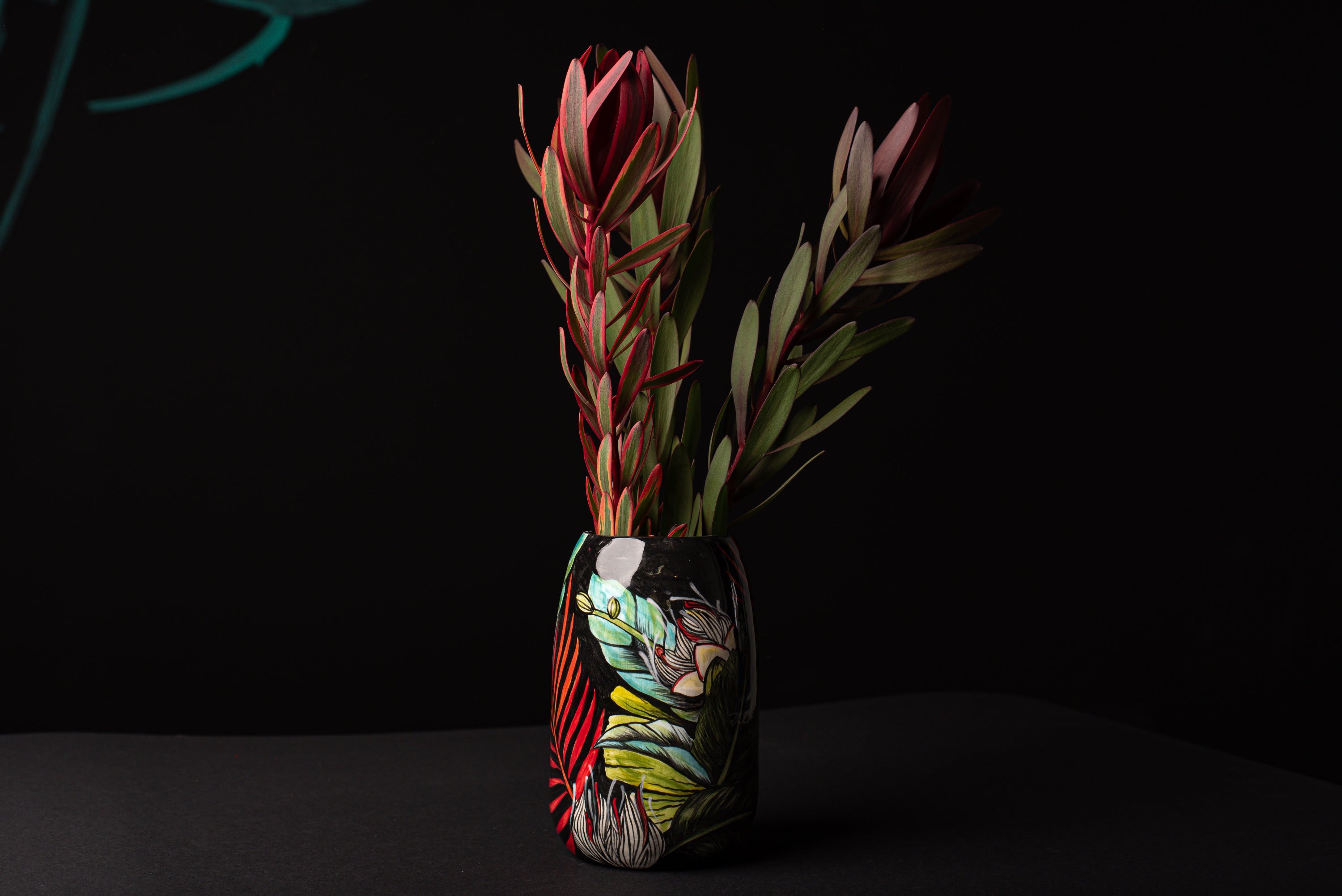 Decorative vase with a floral arrangement on a black background