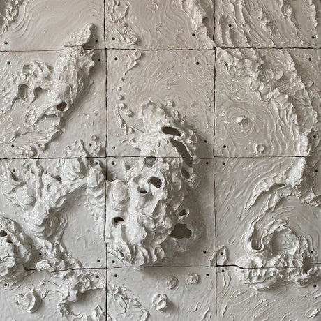 Textured wall panels with a natural landscape design on a black background