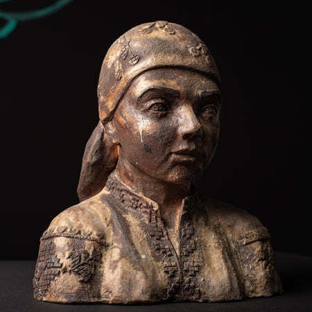 Ceramic bust of a woman with a dark background