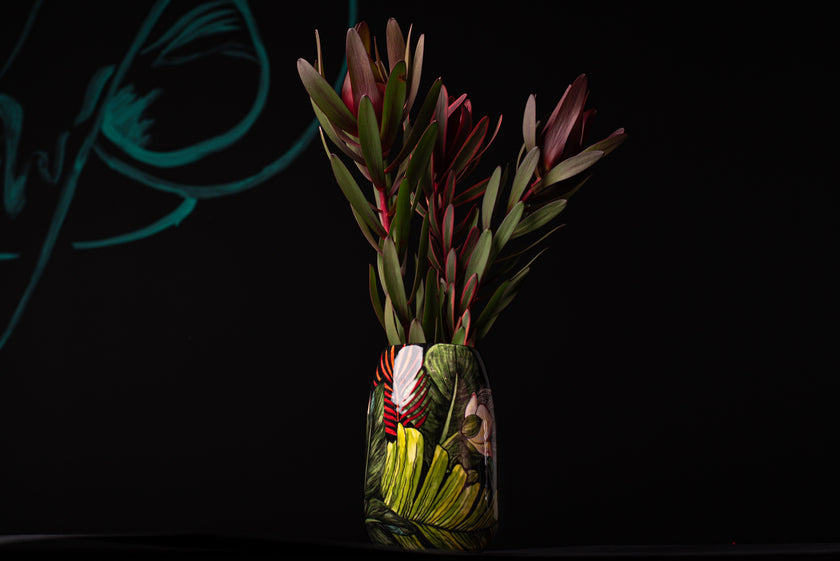 Ceramic vase with plants on a black background