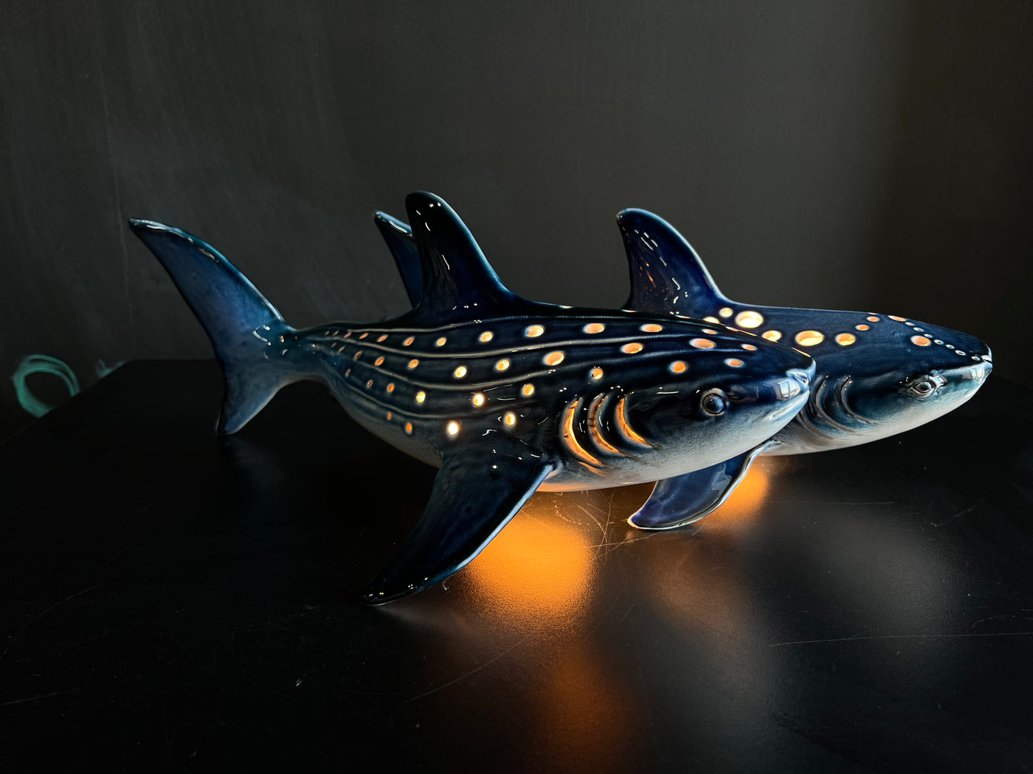Model of a whale shark with glowing spots on a dark background