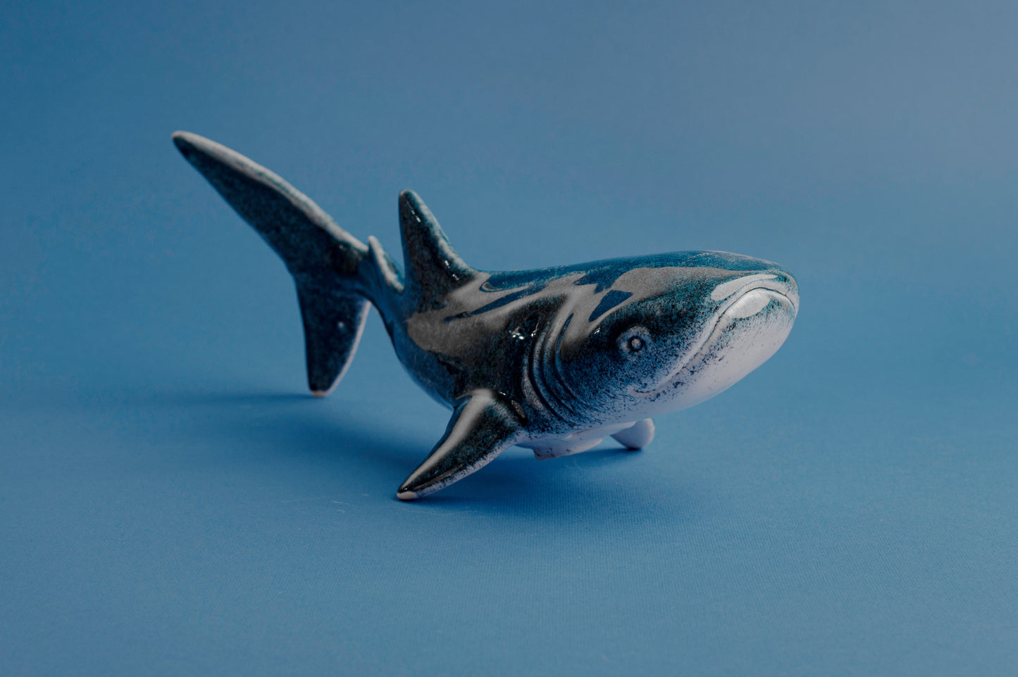 Shark figurine on a blue background